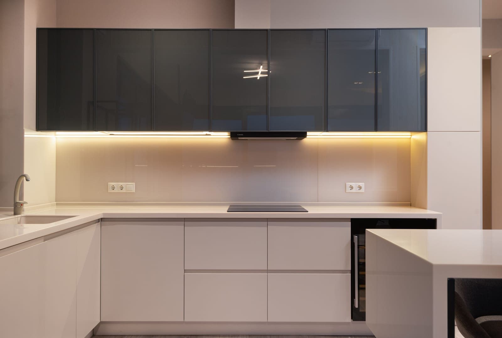 A bright modern kitchen with minimalist cabinets and ceiling lighting