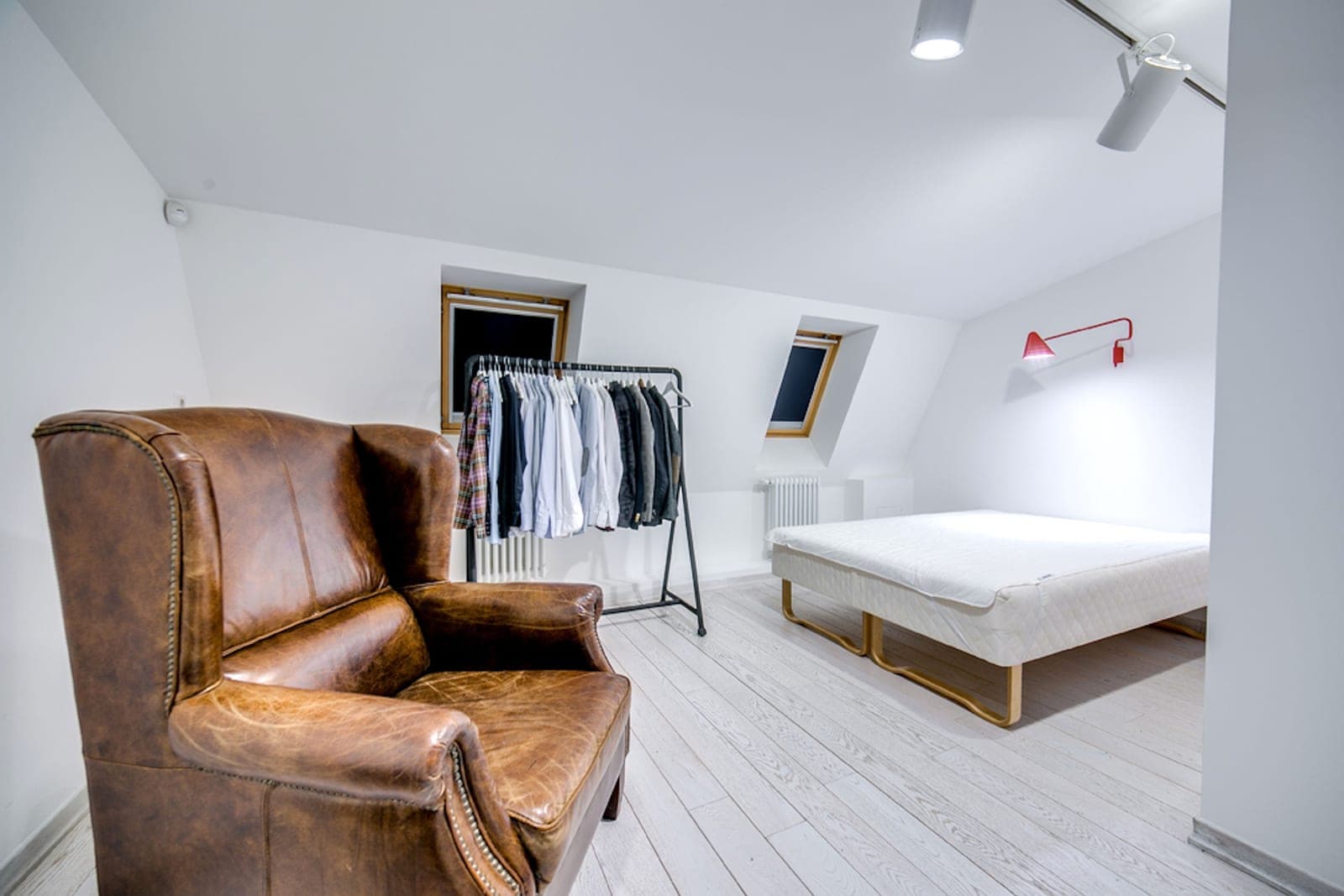 A converted loft room with sloped ceilings and warm lighting
