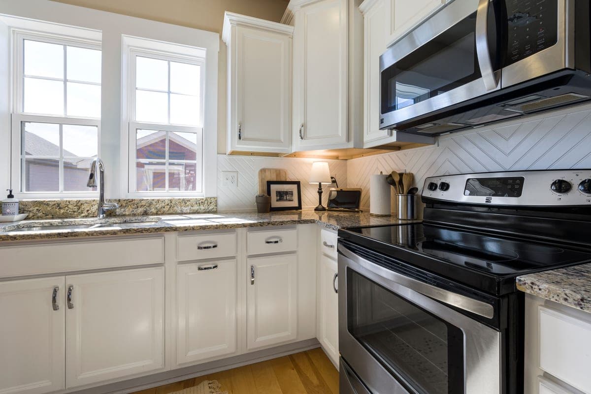 Close-up of kitchen wall cabinets with a light fitted underneath