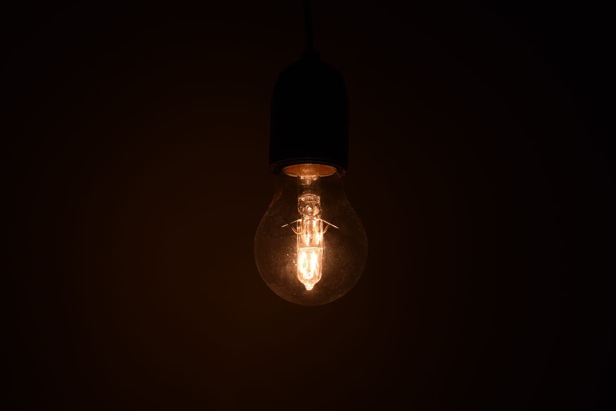 A dim room lit by a single lamp, with the corners falling into shadow