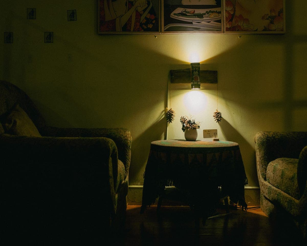 A living room lit low by dimmed warm lamps