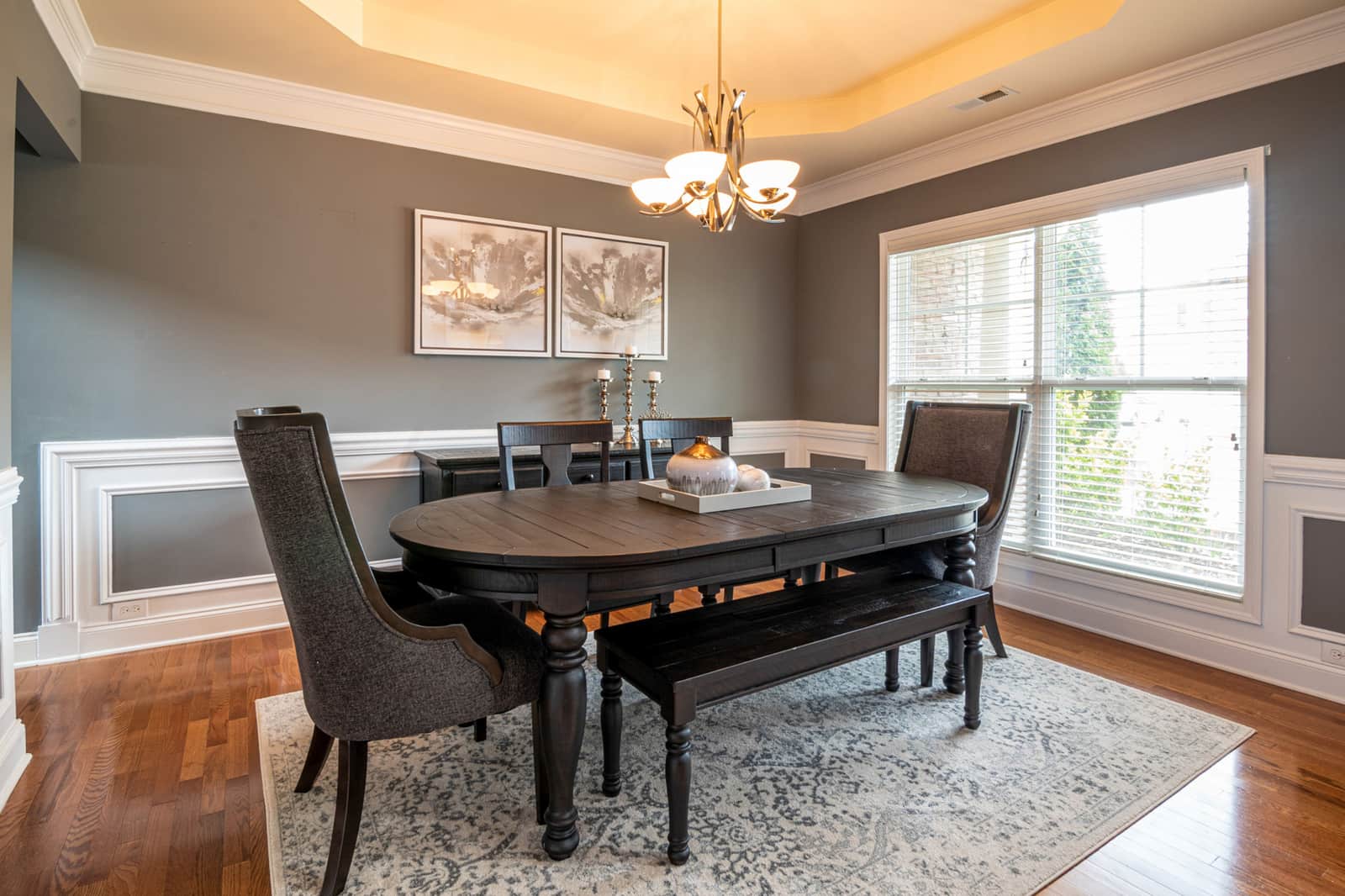 A chandelier hanging above a dining table