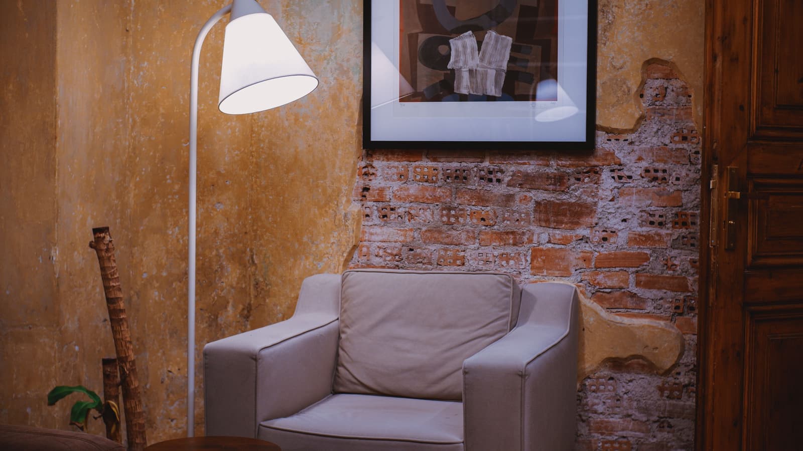 A floor lamp positioned beside an armchair in a living room corner
