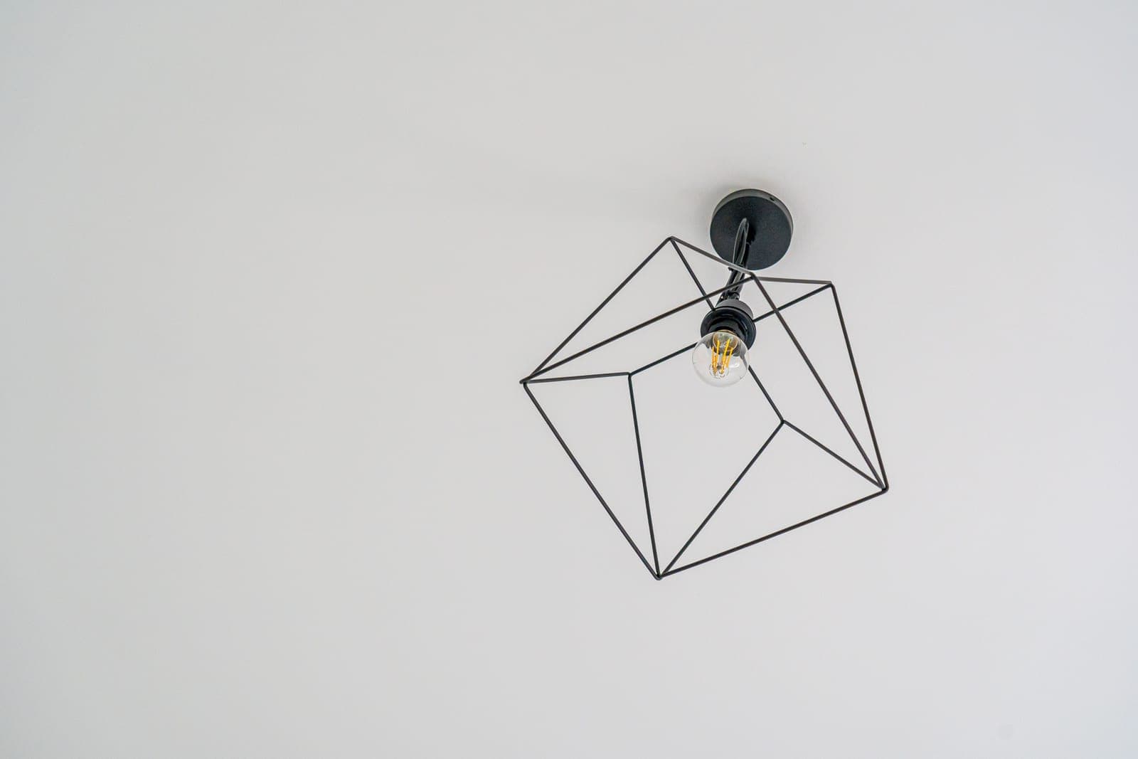 A flush mount ceiling light fitting seen from below