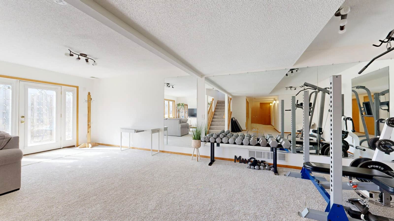 A home gym space lit evenly from the ceiling