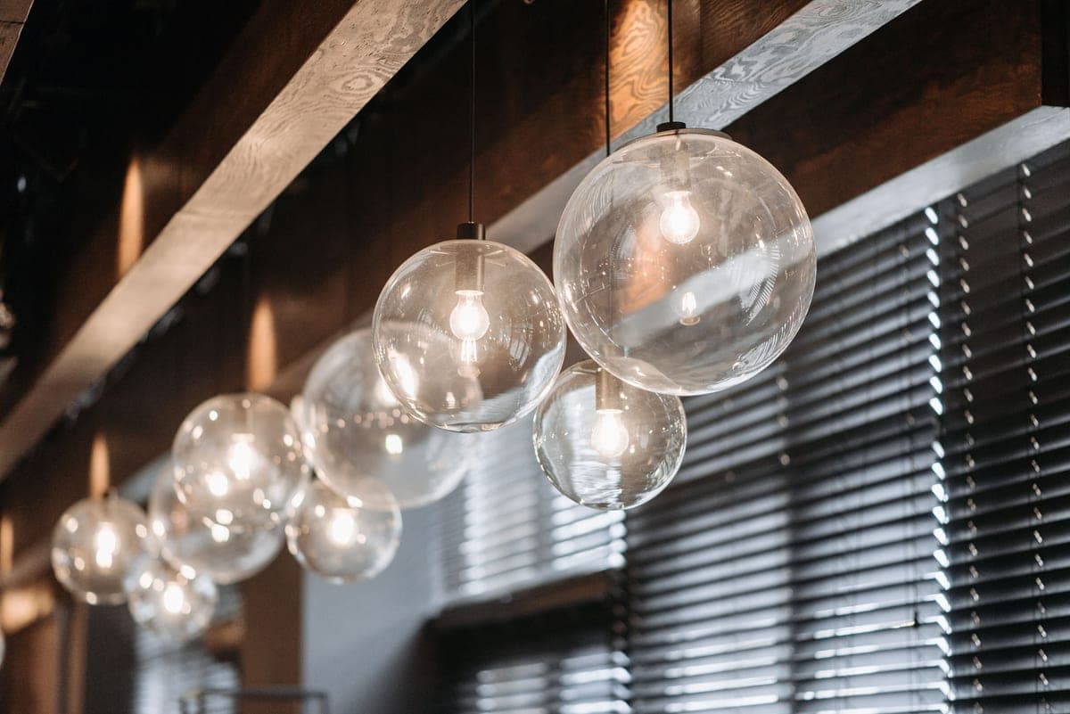 A living room lit by several light sources at different heights, from floor lamp to table lamp