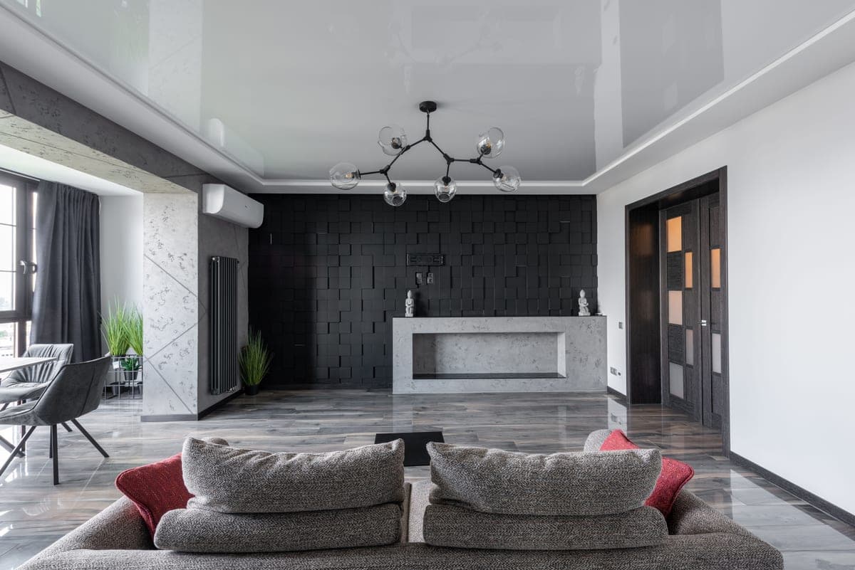 An apartment living room with lamps and a bare ceiling