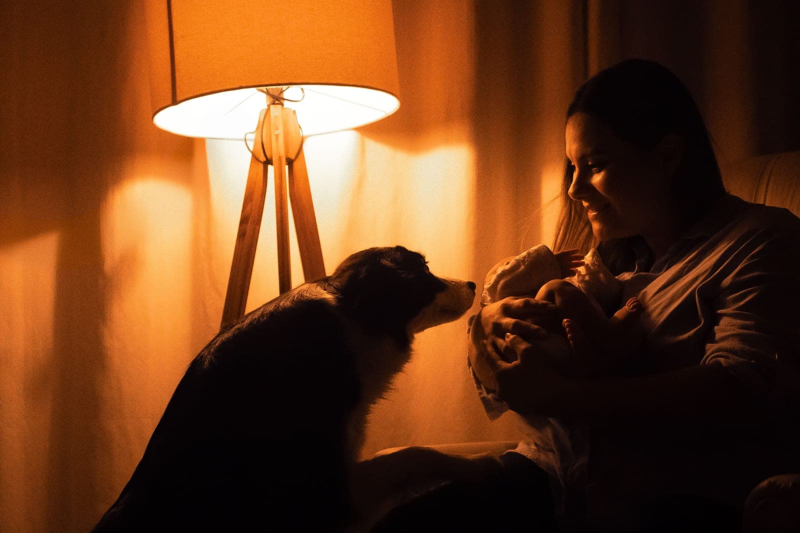 A dimly lit nursery with a soft warm lamp