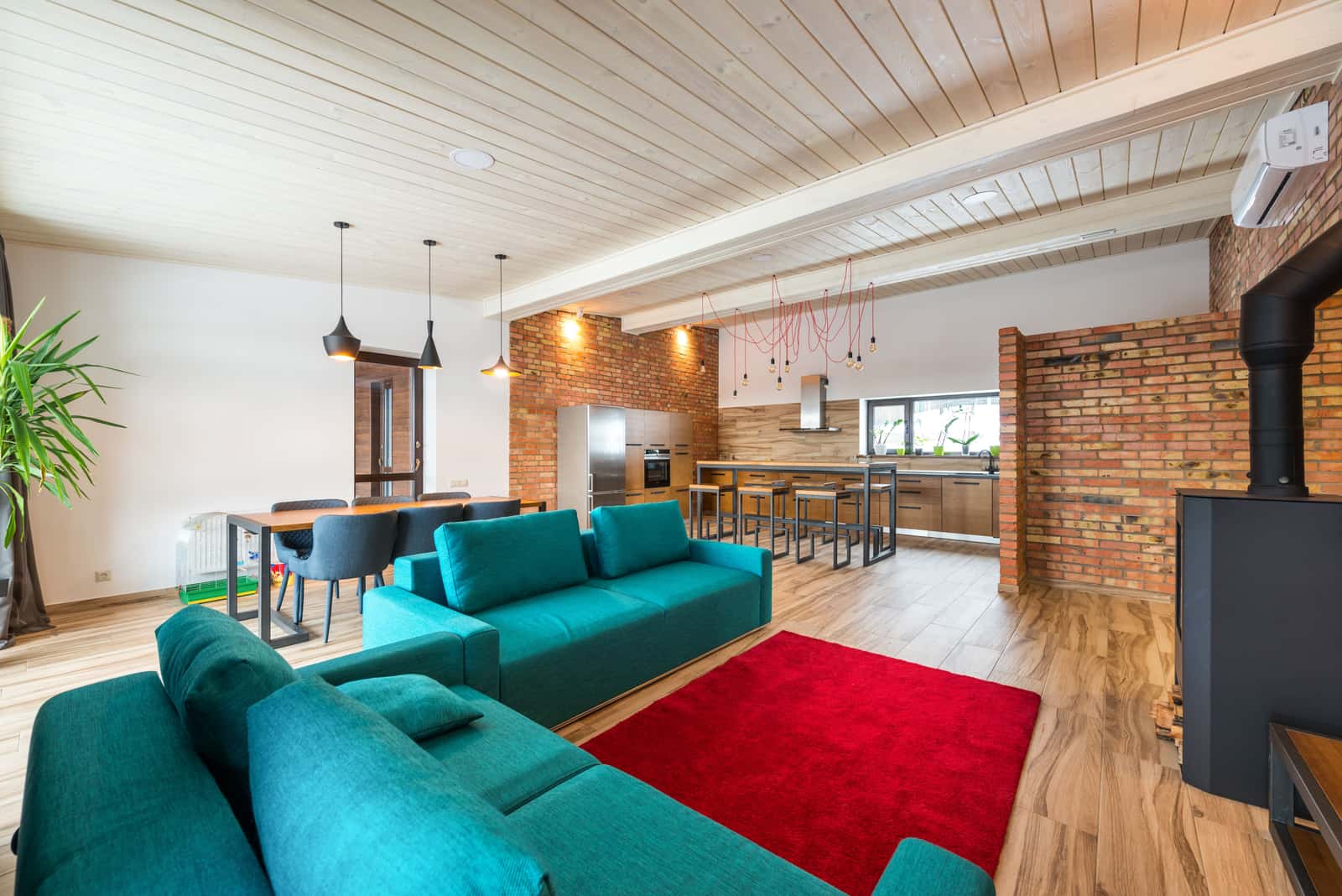 An open-plan kitchen and living space lit in zones