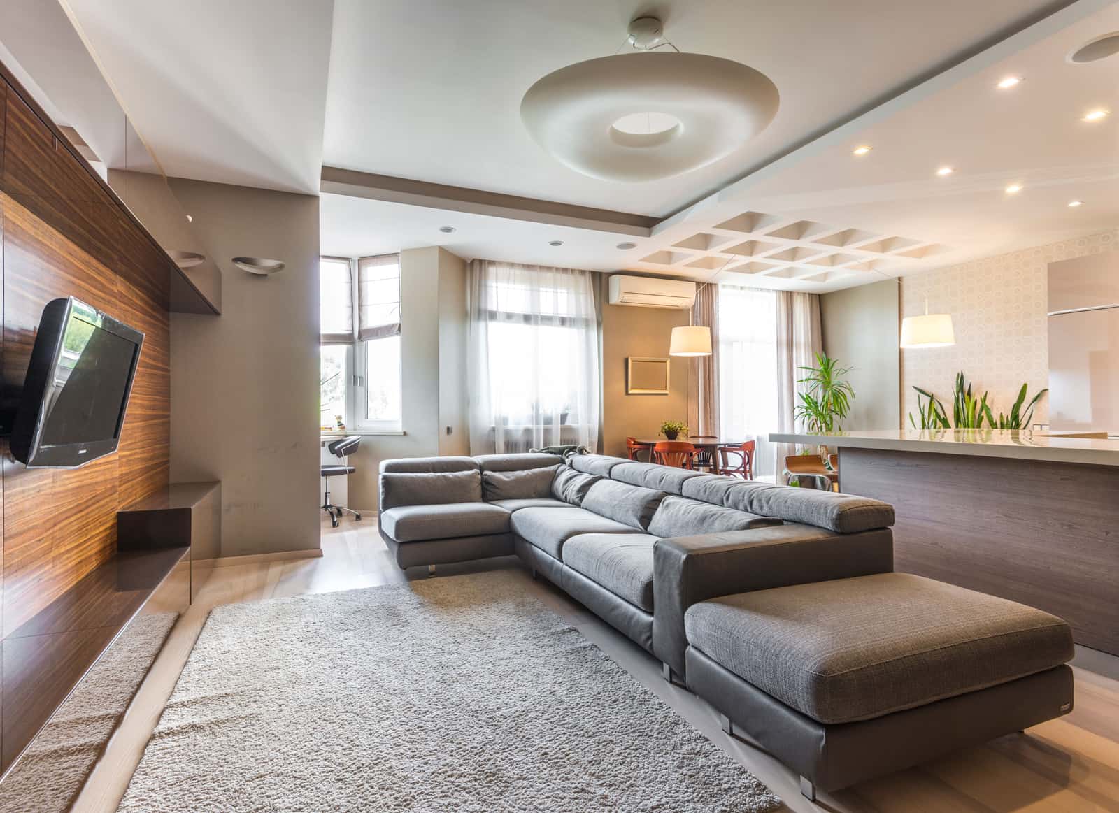 Recessed ceiling lights washing a wall in a living room