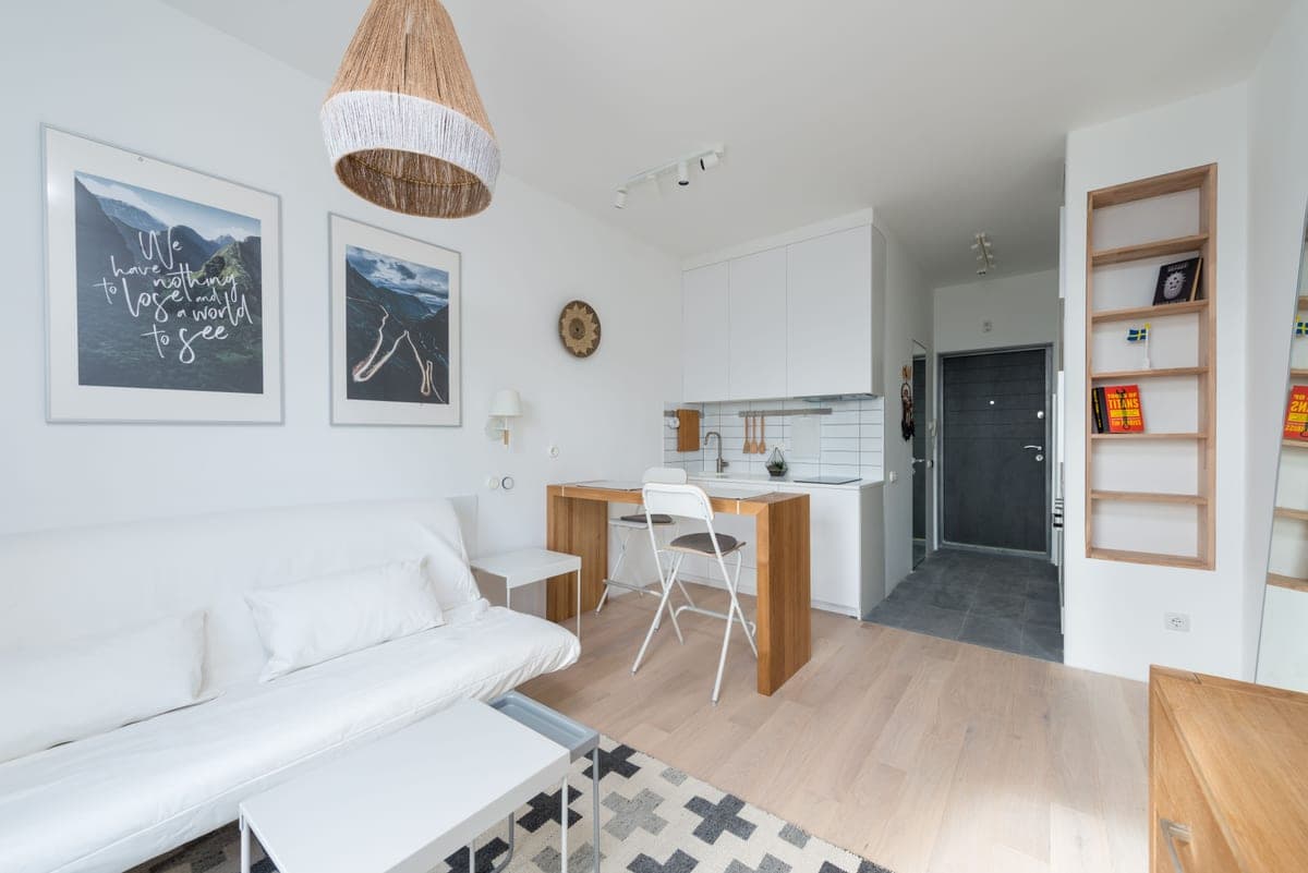 A small apartment living space lit by lamps in the evening
