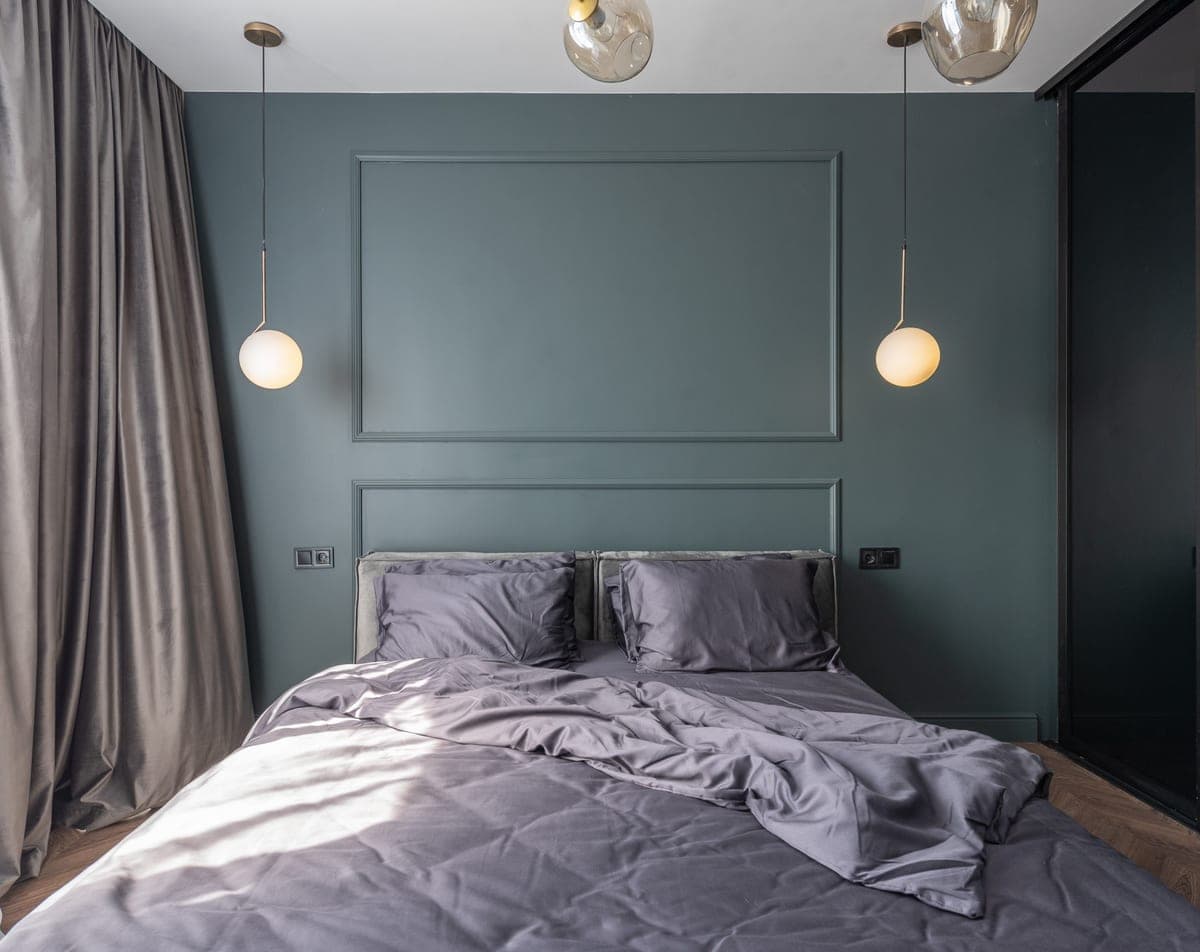 A bedroom lit softly by lamps on both sides of the bed