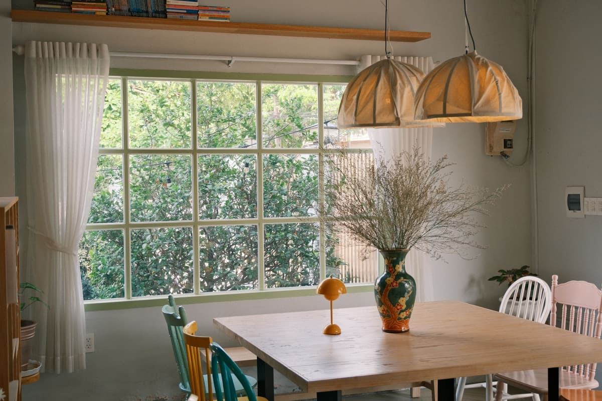 A dining table lit from above by a warm pendant