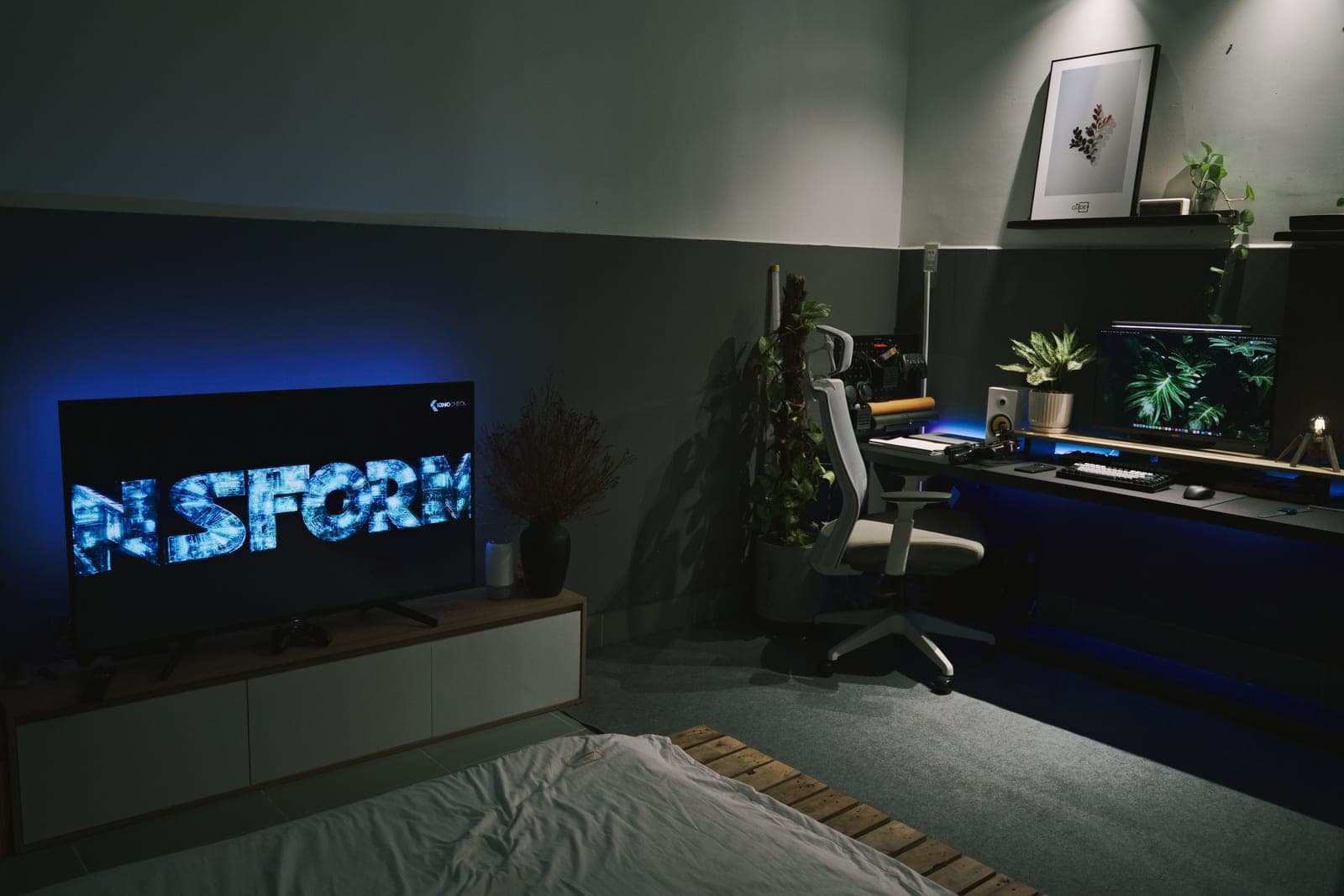 A color LED strip running behind a television in a dark room