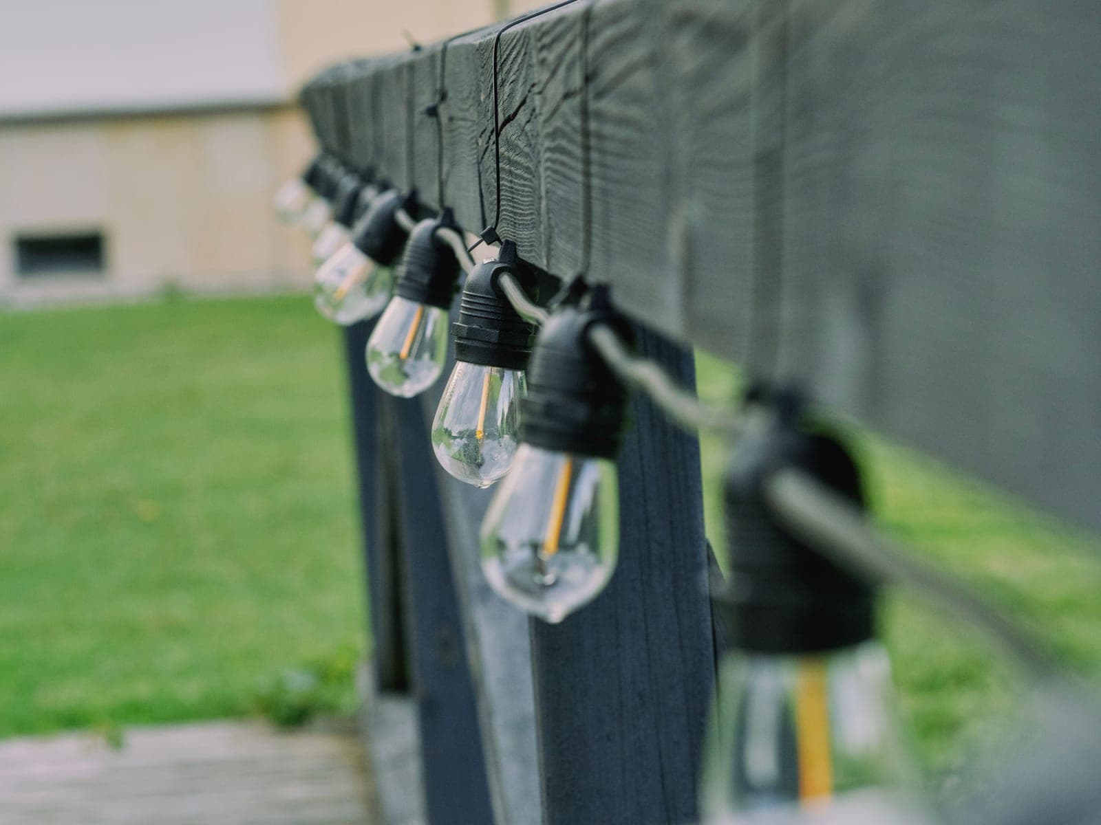 String lights secured along a balcony rail