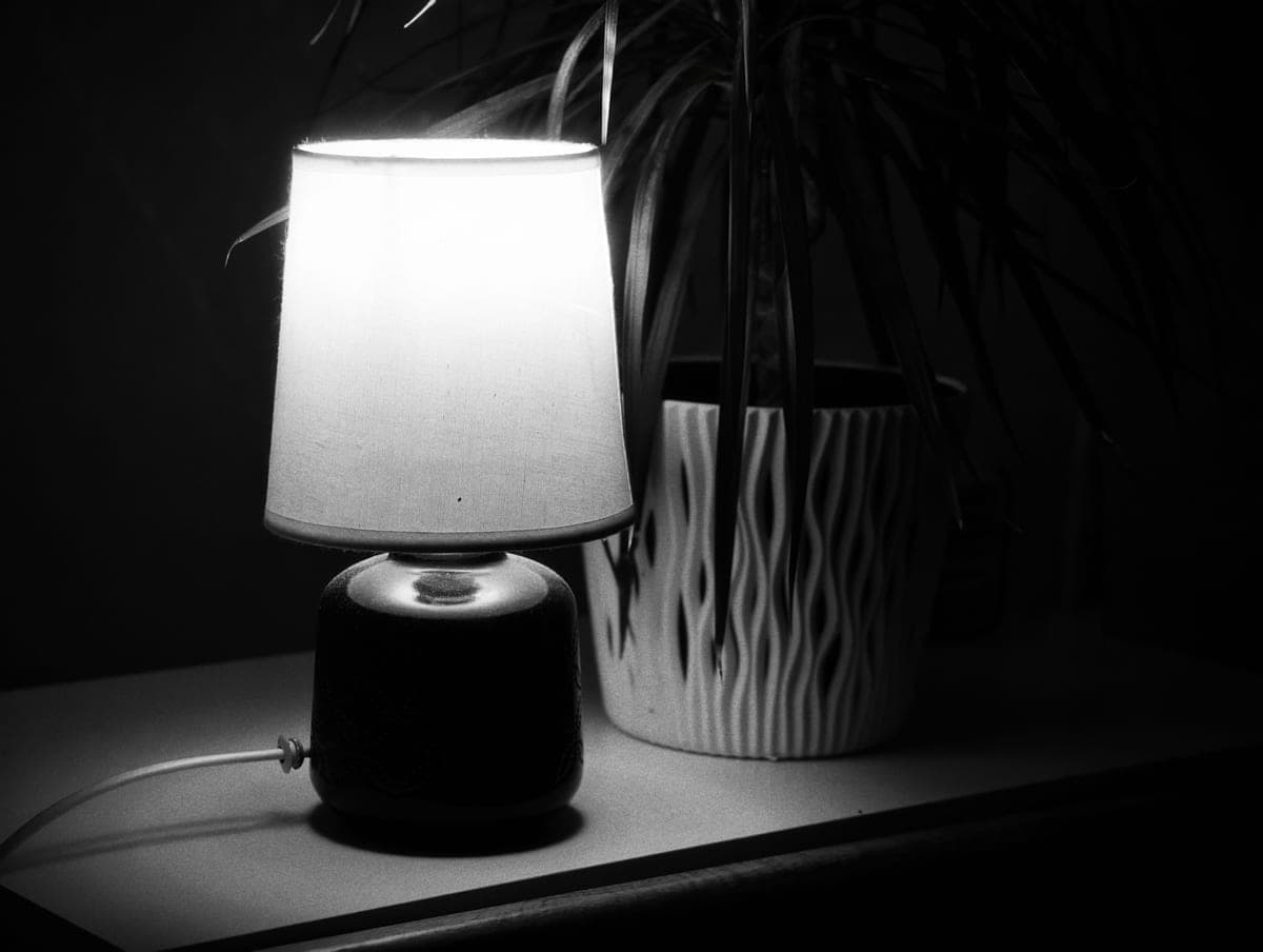 A table lamp casting warm light on a side table