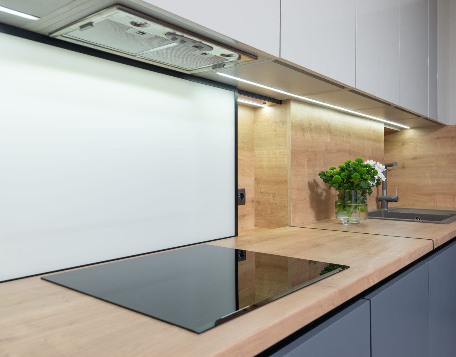 A hidden LED strip glowing along a kitchen toe-kick