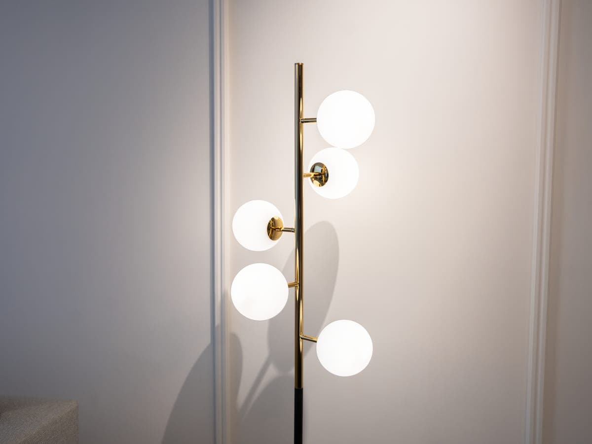 Several modern floor lamps of different shapes in a minimal living room