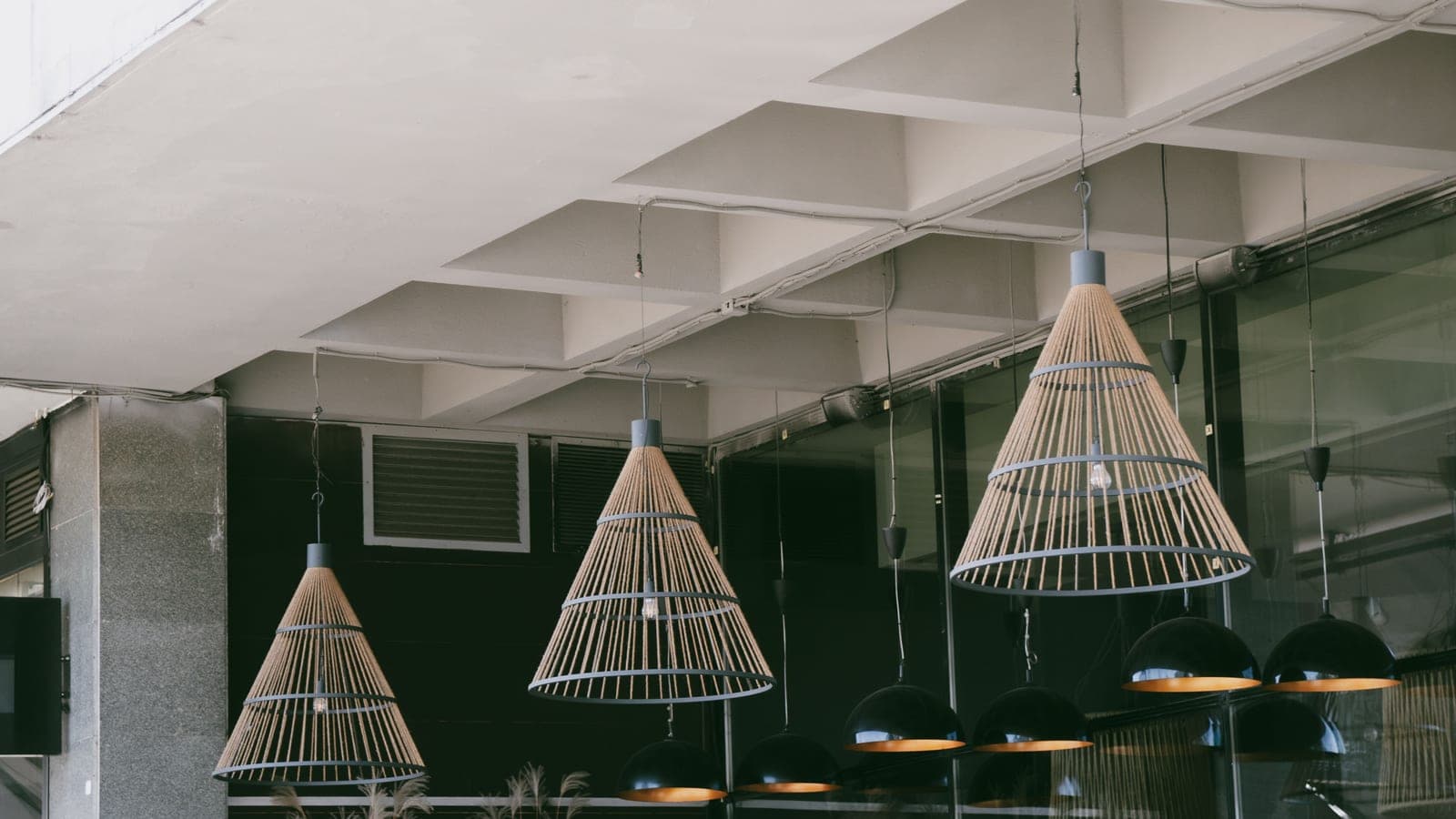 A ceiling fixture and a vanity bar in a lit interior
